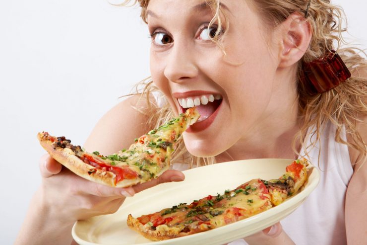 בחורה אוכלת משולש פיצה